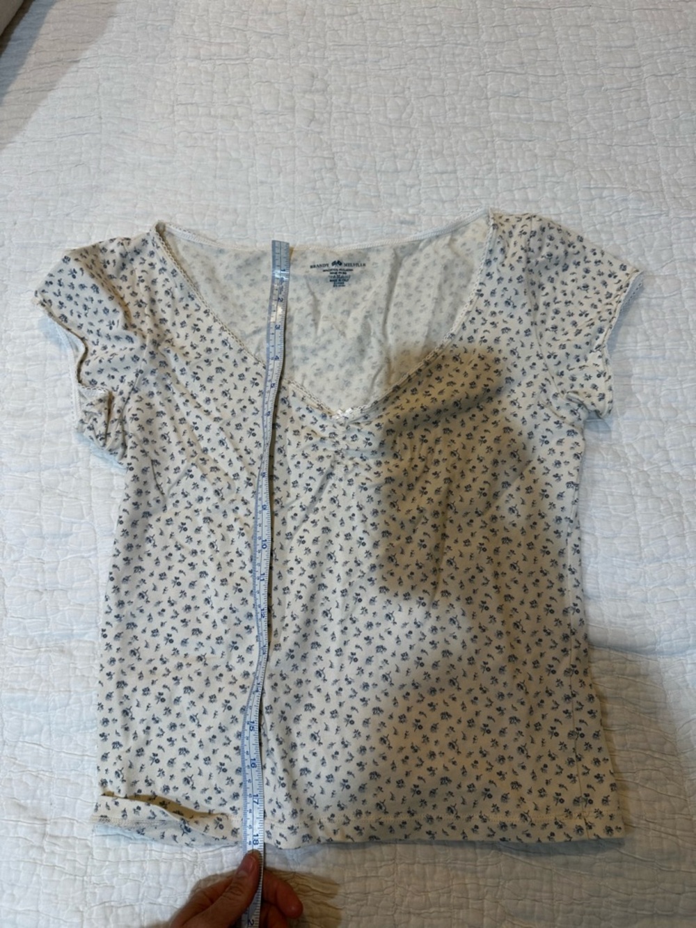 Brandy Melville cream tee with small blue floral print